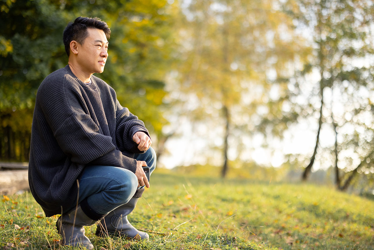 Asian man resting on grass