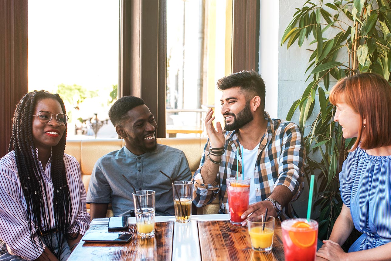 Group of friends laughing over breakfast