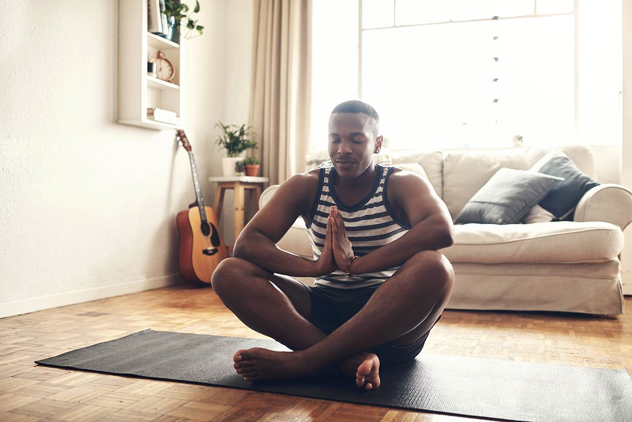 Young man practicing mindfulness with yoga