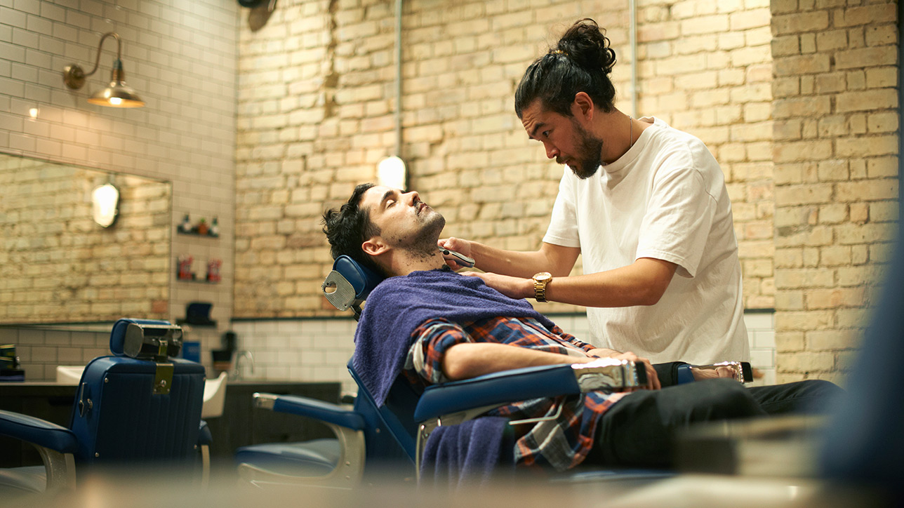 Barber giving customer a shave