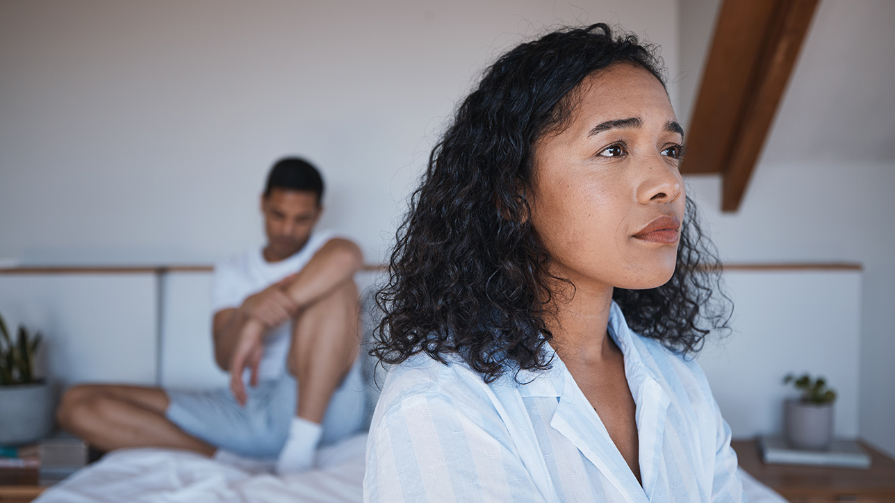 Sad couple in bedroom