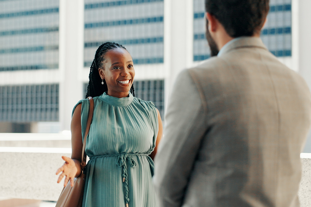 Woman confidently conversing with a coworker Woman confidently conversing with a coworker