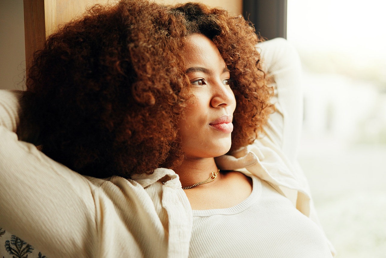 Black woman reflecting and relaxing Black woman reflecting and relaxing