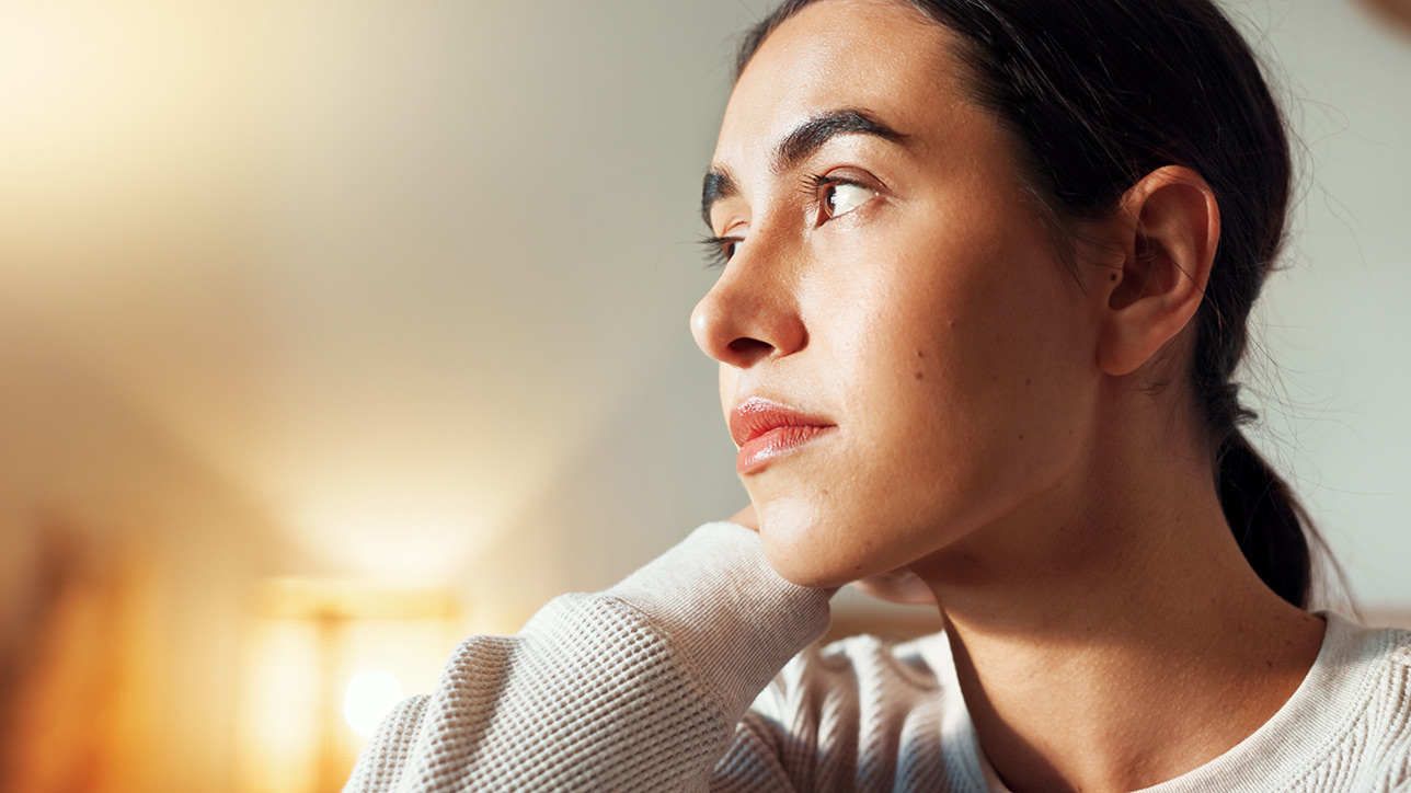 Woman contemplating at home
