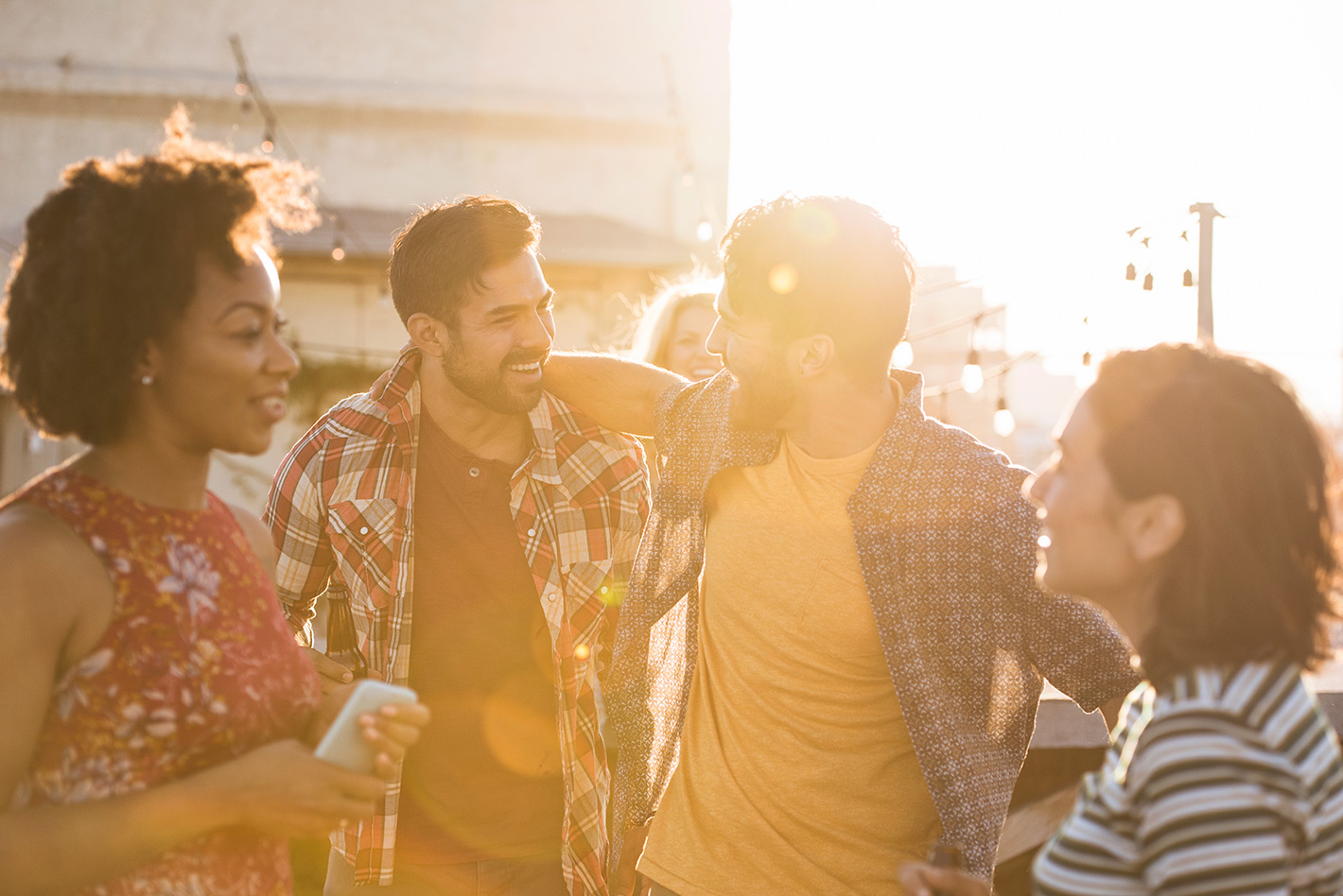 Friends chatting together in bright sunlight